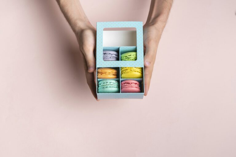 a top view of the french sweet desert - macaroons in the cardboard box