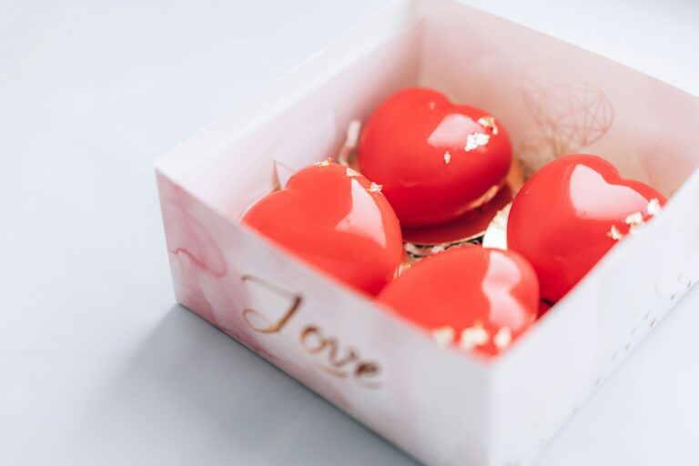 Red heart-shaped cake in a box. Gift for Valentine's Day and Women's Day